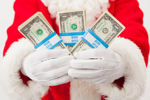 Close-up of Santa Claus holding pile of one dollar bill